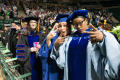 Photograph: [Students Giving Peace Signs at Commencement Ceremony]
