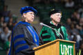 Photograph: [Faculty Members Stand at Podium Delivering Speech]