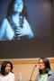 Photograph: [Beatriz Terrazas and Nikki Kahn sitting in front of screen]