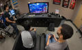 Photograph: [Students playing video games during International Game Day event]