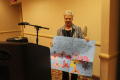 Photograph: [Attendee holding up poster]