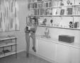 Photograph: [Bobbie Wygant in front of bookcase]