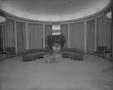 Photograph: [Oval room with sofas and mirrors]