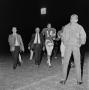 Photograph: [Odus Mitchell walking with players]