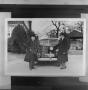 Photograph: [Two men standing in front of a car, 2]