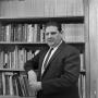 Primary view of [Photograph of Dr. Friedsam at his bookshelf #3]