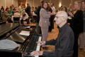 Photograph: [Bob Rogers playing piano at holiday event]