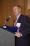 Photograph: [Wesley R. Turner speaking into microphone at TDNA conference]