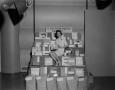 Photograph: [Woman posing with door prizes, 2]