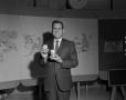 Photograph: [Weatherman holding products]