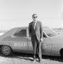 Primary view of [Budd Kneisel standing in front of WBAP car]