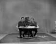 Photograph: [Budd Kneisel and Johnny Hay with newspapers]