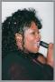 Primary view of [Unidentified singer at Christmas Kwanzaa soiree]