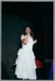 Photograph: [Miki Howard singing onstage in all white garb]