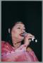 Photograph: [Low-angled shot of Angela Bofill singing into microphone]
