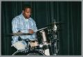 Photograph: [Photograph of a man playing a small drum set]