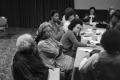 Photograph: [Photograph of individuals attending a conference meeting]