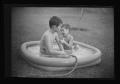 Photograph: [Tim and Byrd in a kiddie pool]
