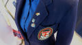 Photograph: [Ursuline Academy jacket and pins]