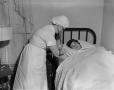 Photograph: [Nurse checking a patient's vitals]