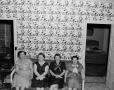 Photograph: [Four women sitting on a couch]