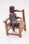 Photograph: [Penny wooden doll in chair]
