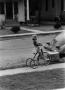 Primary view of [Photograph of Carol Williams riding a tricycle]