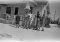 Photograph: [Photograph of individuals posing in a snowy lawn]