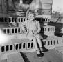 Photograph: [Photograph of young Carol Williams sitting on cinder block steps, 2]