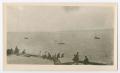 Photograph: [Photograph of a crowd of people sitting on a dock]