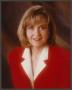 Primary view of [Photograph of a headshot of Jane McGarry in a red suit]