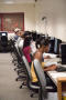 Photograph: [Students in a row at Matthews Hall computer lab]
