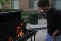 Photograph: [Student pulling hand back from grill fire]