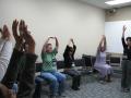 Photograph: [People stretching in a classroom]