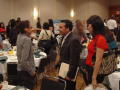 Photograph: [Students and staff mingling at event]