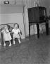 Photograph: [Photograph of Pam and Byrd Williams IV as toddlers in front of a fir…