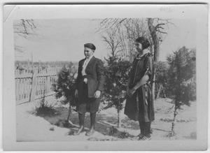 Primary view of object titled '[A girl and boy standing outdoors]'.