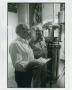Photograph: [Two men taking readings from the distillery]