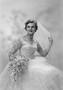 Photograph: [Portrait of Jane Williams in a wedding dress, holding a bouquet, one…