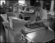 Photograph: [Book Bindery - Process - Male Individual - Measuring - 1963]