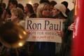 Photograph: [Photograph of a woman holding a Ron Paul sign]