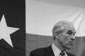 Photograph: [Photograph of Ron Paul in front of Texas flag]