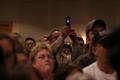 Photograph: [Photograph of a man taking a cell phone picture at Ron Paul rally]