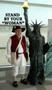 Photograph: [Tom Van Fossen stands with miniature Statue of Liberty at naturaliza…