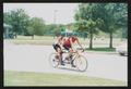 Photograph: [Cyclists on a tandem bike riding in a parking lot: Lone Star Ride 20…