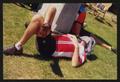 Primary view of [Cyclist resting on the ground with a towel over their face: Lone Star Ride 2001 event photo]