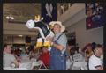 Photograph: [Crew member holding an inflatable cow: Lone Star Ride event photo]