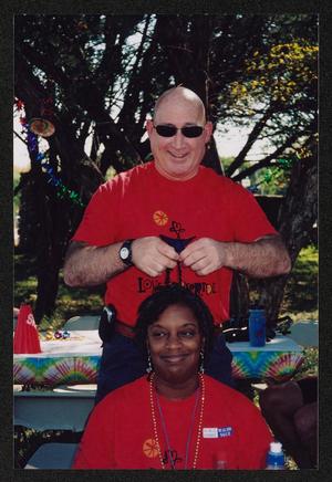 Primary view of object titled '[A crew member playing with another's hair: Lone Star Ride 2005 event photo]'.