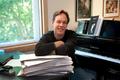 Photograph: [Jake Heggie with sheet music and piano, 1]