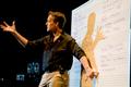 Photograph: [Jake Heggie speaking and pointing to a whiteboard, 2]